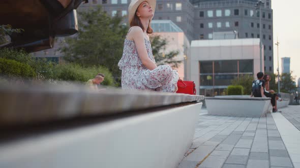 Young happy girl on a bench 