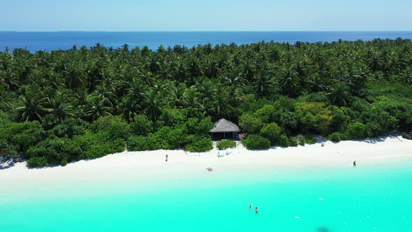 Wide angle aerial island view of a paradise sunny white sand beach and aqua blue ocean background in