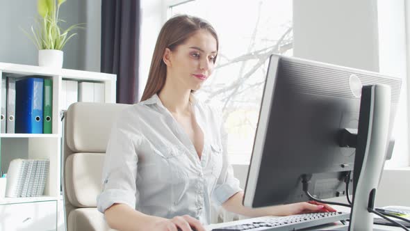 Young Woman Works at Home Office Using Computer.