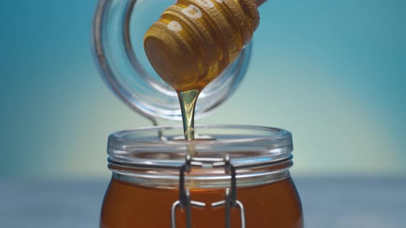 Pouring Fresh Honey on Blue