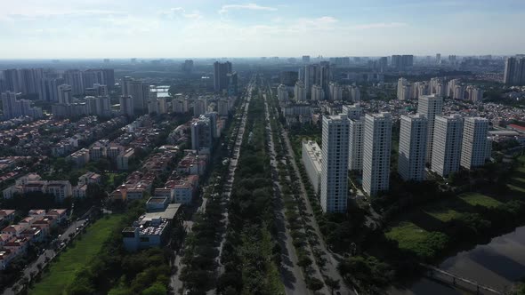 Drone fly in shot along modern highway in Ultra modern city with river, green space, high rise build