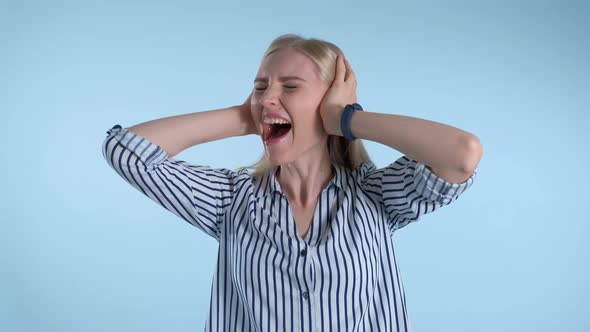 Scared Desperate Woman Screaming and Covering Ears on Blue Background