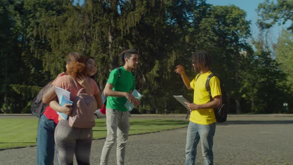 Multiethnic Couple Saying Bye To Fellow Students