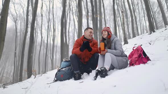 Couple Talking While Sitting in Forest