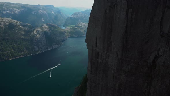 Epic view down from Preikestolen edge in to the abyss of Pulpit Rock in Norway.