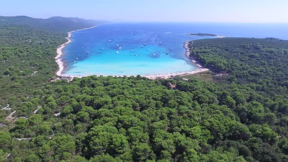 Aerial view of boats in a beautiful azure lagoon with highway in the foreground