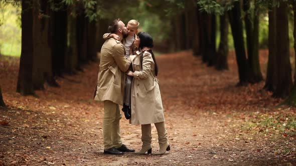 A Happy Family is Walking in the Park