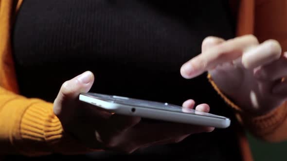 Person's hands using a tablet