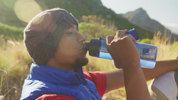 Sporty mixed race man with prosthetic leg drinking water