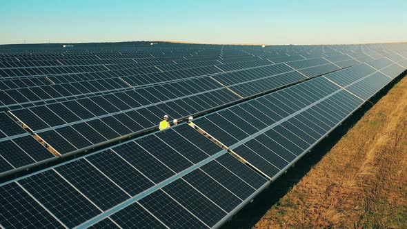 Aerial Shot Three Solar Energy Engineers Large Solar Farm