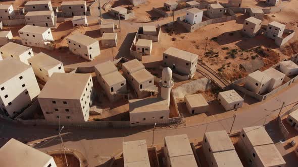 aerial shot of an old empty city in the desert in palestine near Gaza while cameraes closer to the b