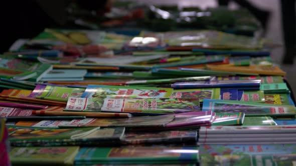 Vendors Hands Sorting Through Pile of Magazines
