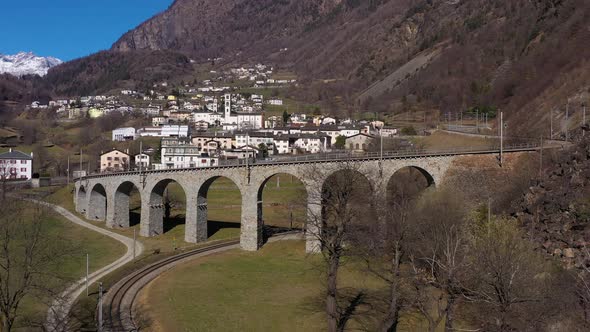 Train on Brusio Spiral Viaduct in Switzerland