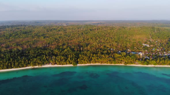 Aerial: uncontaminated white sand beach sunset at Kei Islands Maluku Indonesia