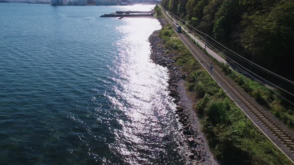 Drone Over Train Between Coast And Forest