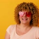 Cheerful 30s Woman with Afro Hairstyle Having Fun on Yellow Background - VideoHive Item for Sale