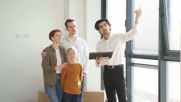 Pleasant Confident Caucasian Real Estate Agent In Formal Wear Representing New House To Customers