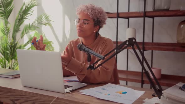 African Female Making an Online Podcast Recording for Her Online Show