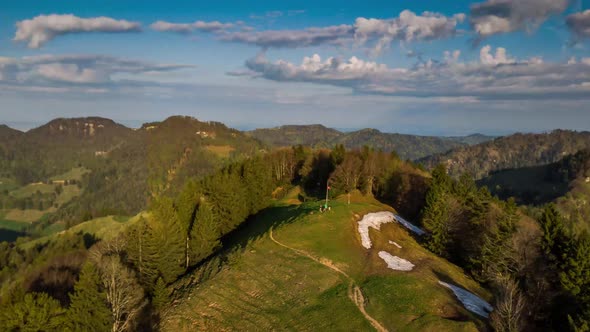 The dronees around a mountain top really fast.