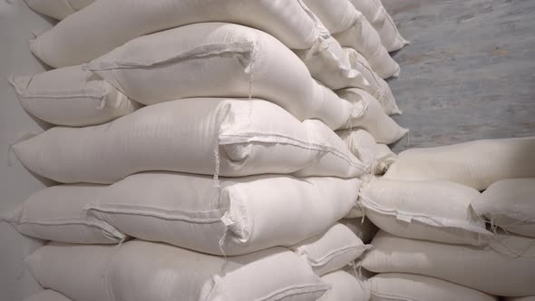 In stock, rice, sugar, cereals and flour are prepared in bags for shipment