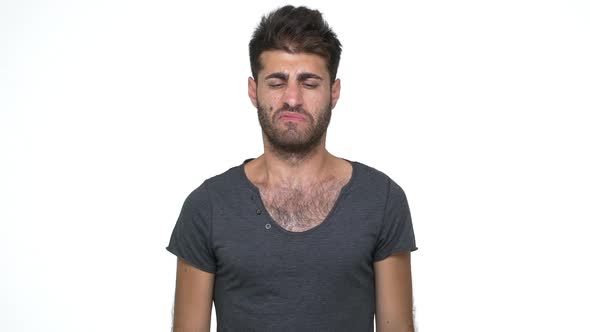 Slomo Skinny Young Man Wearing Grey Tshirt Pinching Nose with Disgust on His Face Due to Bad Smell