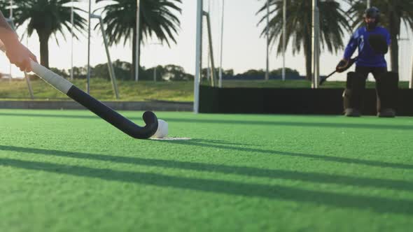 Female hockey players playing on the field