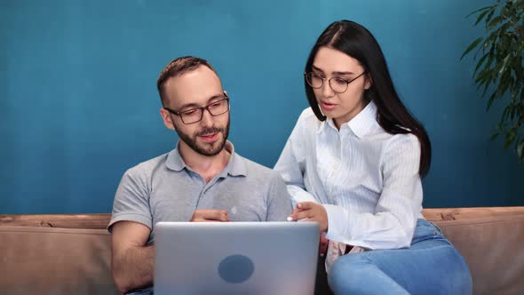 Business People Discussing Project Pointing at Screen of Laptop