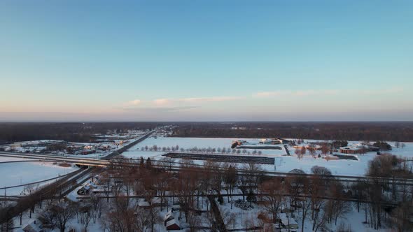 Aerial drone view of suburb area in cold winter day against blue sky