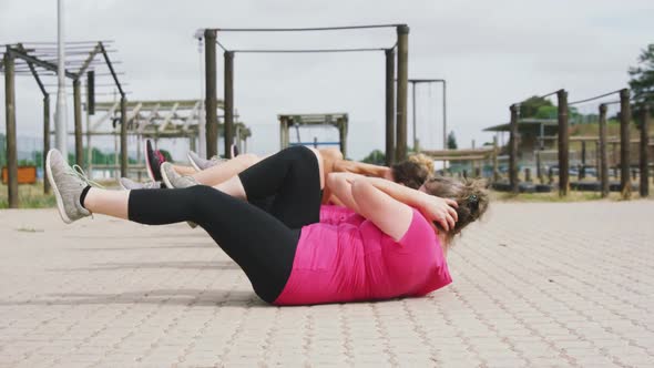 Female friends enjoying exercising at boot camp together