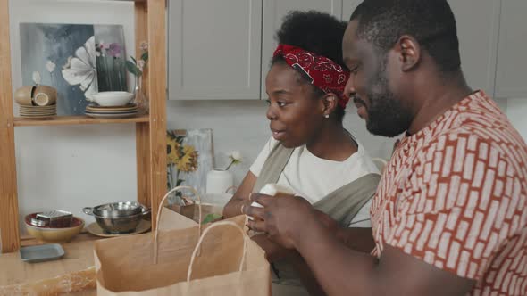 African-American Family Unpacking Paper Bags with Food Products