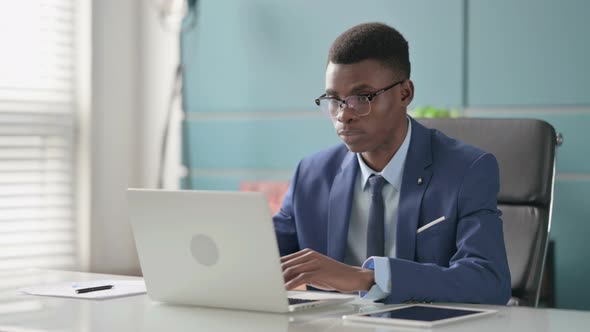 Young African Businessman Working on Laptop in Office