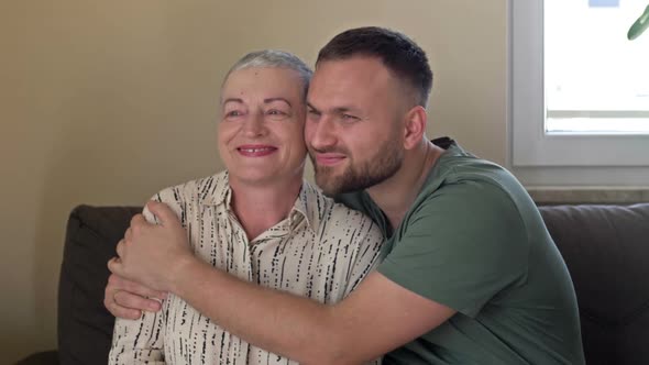 An Adult Son Hugs His Mother