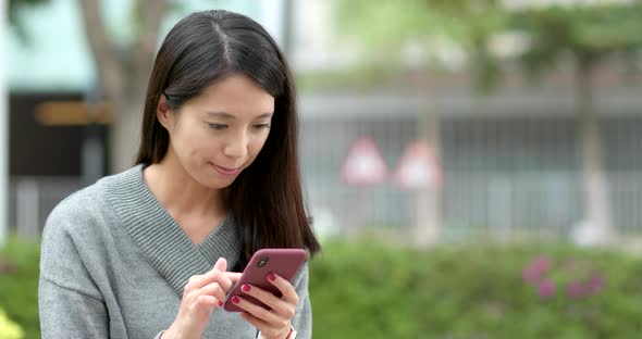 Woman work on mobile phone at outdoor