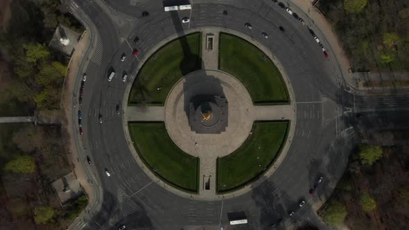 AERIAL: Overhead Birds Eye Drone View Rising Over Berlin Victory Column Roundabout with Little Car