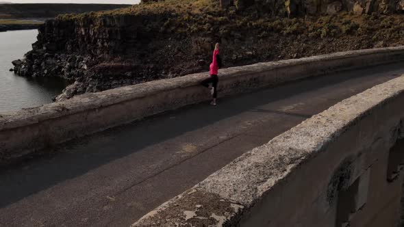 Aerial of a woman hiking across the Salmon Falls Dam in Southern Idaho