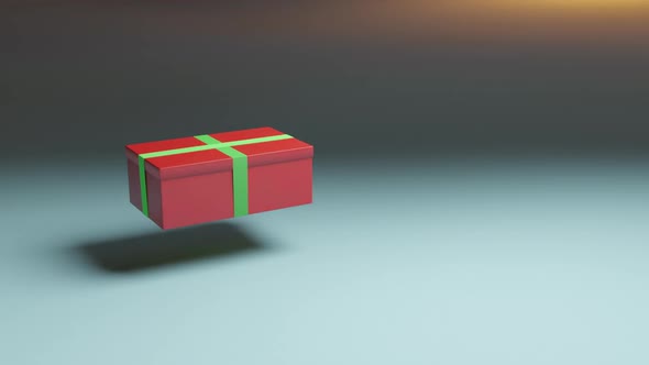 Gift in red box with green ribbon floating in the air. New year and Christmas present.
