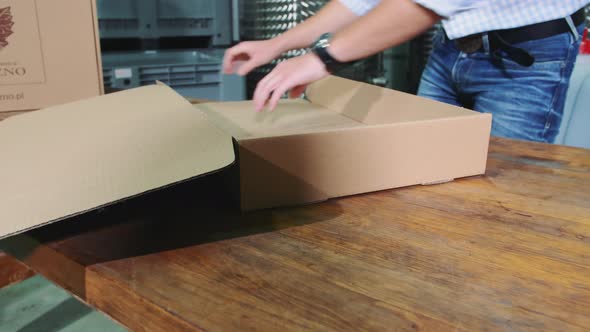 Man Folding Cardboard Box