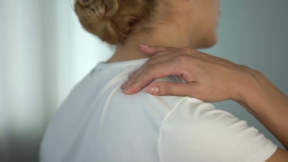 Woman Suffering Shoulder Pinched Nerve and Massaging Painful Body Part, Trauma