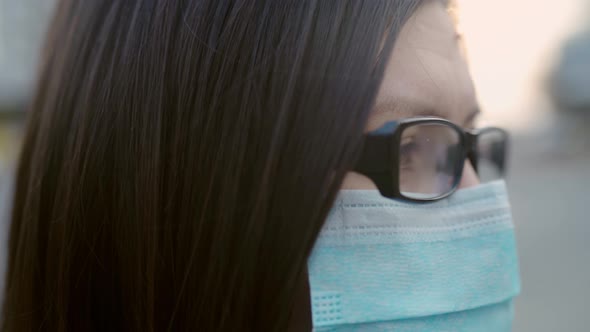 Closeup Eyes of a Girl in Glasses and a Medical Mask