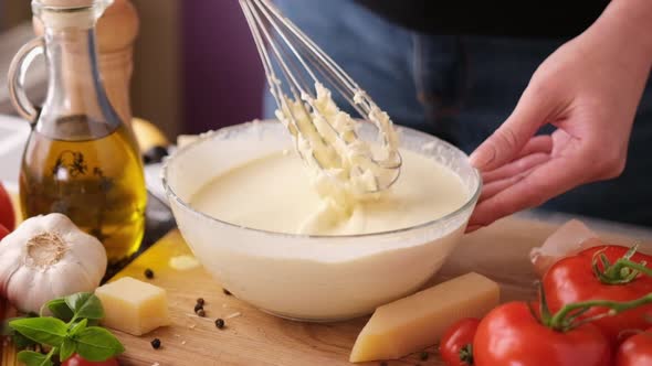 Making Pasta Carbonara Sauce  Mixing Grated Parmesan Cheese and Cream in Glass Bowl