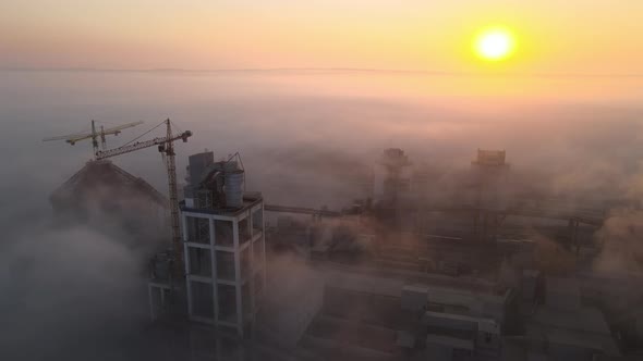 Aerial View of Cement Factory with High Concrete Plant Structure and Tower Crane at Industrial