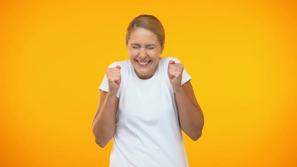 Excited Woman Rejoicing Good News on Bright Background, Amazement, Success