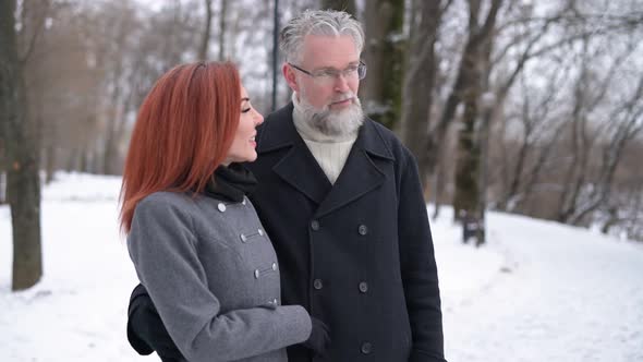 Husband and wife walk in the park and enjoy the views, contemplate the landscape