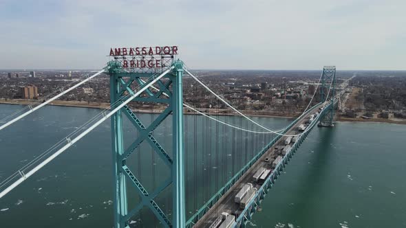 Ambassador bridge logo with endless line of trucks crossing USA - Canada border. Aerial view