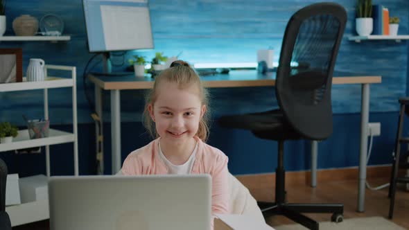 Portrait of Young Girl Smiling and Holding Laptop at Home