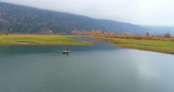 Man rowing a boat on a lake 4k