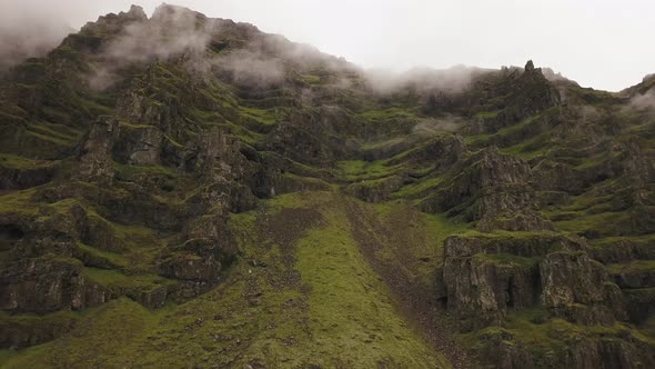 An aerial of a lush mountain on a moody day in iceland