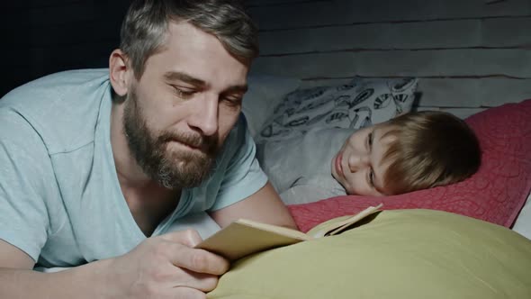 Lovely Boy Listening to Dad Reading Fairytale