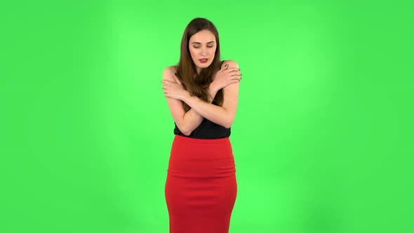 Beautiful Sweet Girl Froze and Trying To Keep Warm Against Green Screen