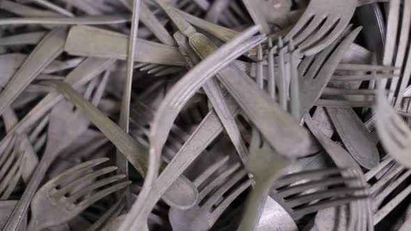 Pile of aged, tarnished forks, mixed design old collectible flatware